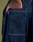 Close up of Isaac's hand in the back pocket of Denim Drop Pocket Pants in Dark Wash