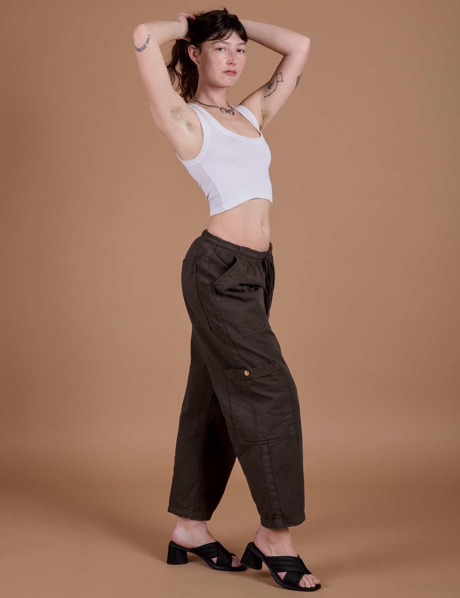 Side view of Drop Pocket Cargo Pants in Espresso Brown and Cropped Tank in Vintage Tee White on Alex