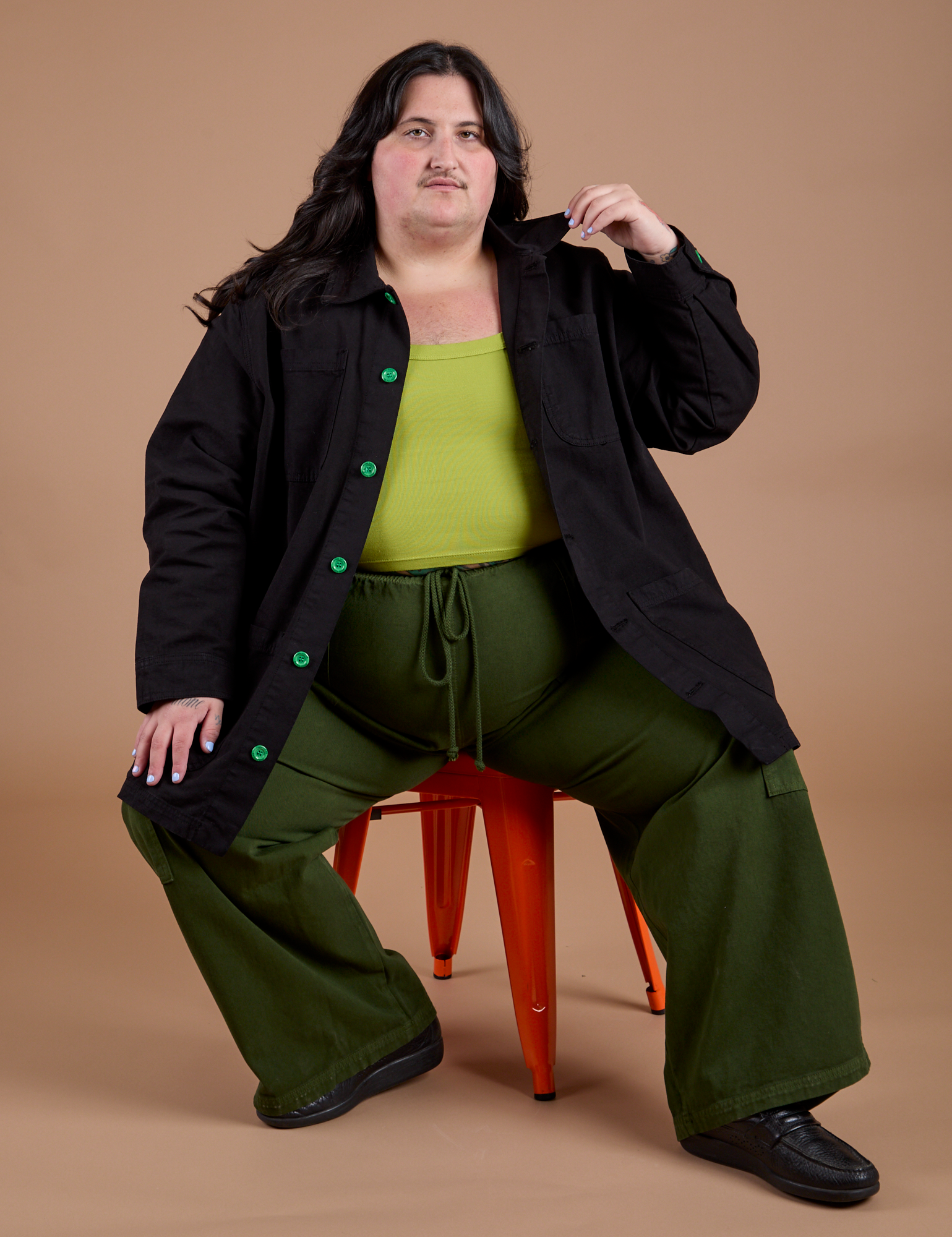 Sam is wearing Ripstop Field Coat in Basic Black and evergreen Drop Pocket Cargo Pants