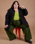 Sam is wearing Ripstop Field Coat in Basic Black and evergreen Drop Pocket Cargo Pants