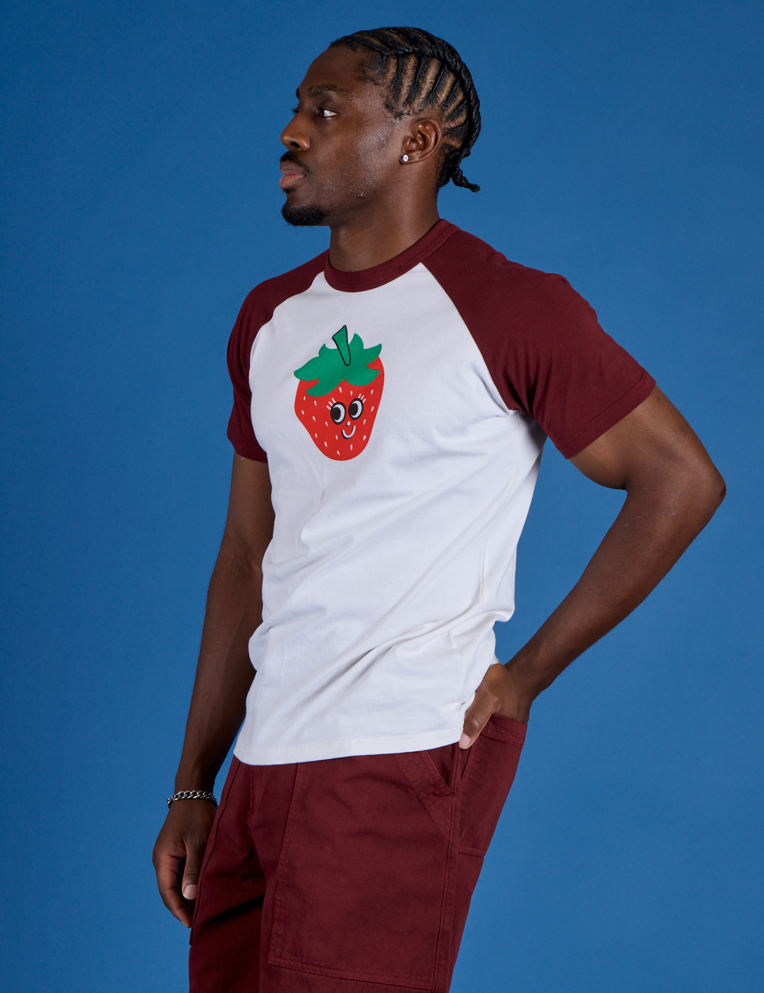 Angled view of Produce Raglan Tee in Strawberry on Isaac