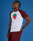 Angled view of Produce Raglan Tee in Strawberry on Isaac