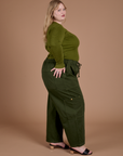 Side view of Gingham Long Sleeve Baby Tee in Summer Olive and evergreen Drop Pocket Cargo Pants