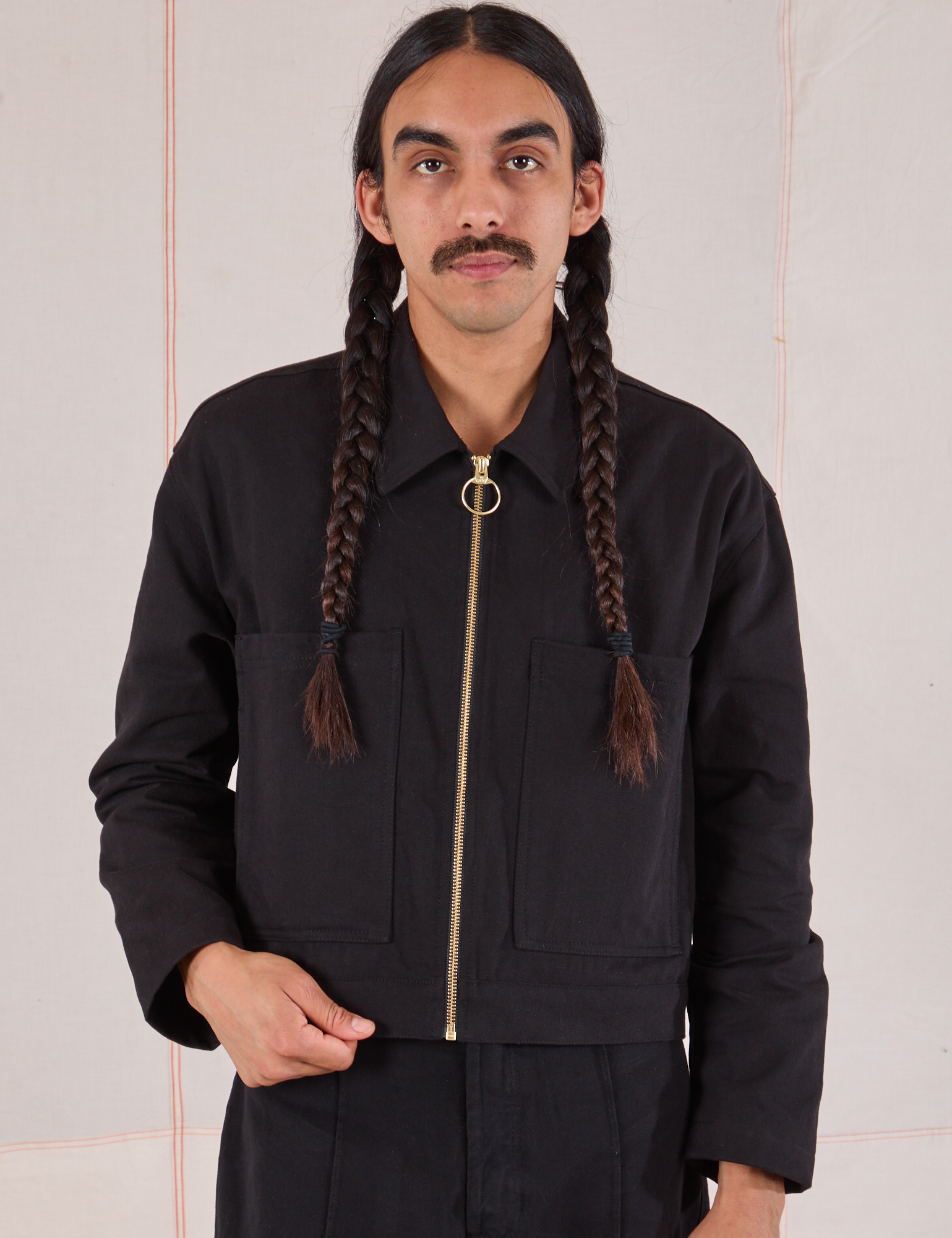 Anthony is wearing a zipped up Mechanic Jacket in Basic Black