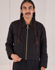 Anthony is wearing a zipped up Mechanic Jacket in Basic Black
