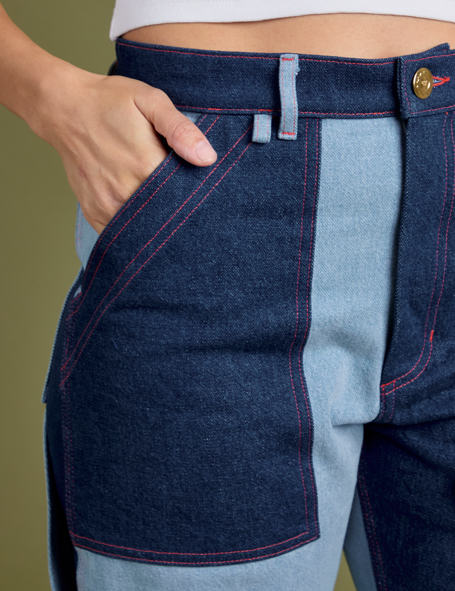 Close up of Tiara's hand in the front pocket of Mismatched Denim Carpenter Jeans