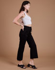 Side view of Organic Action Pants in Basic Black and vintage tee white Cropped Tank on Alex