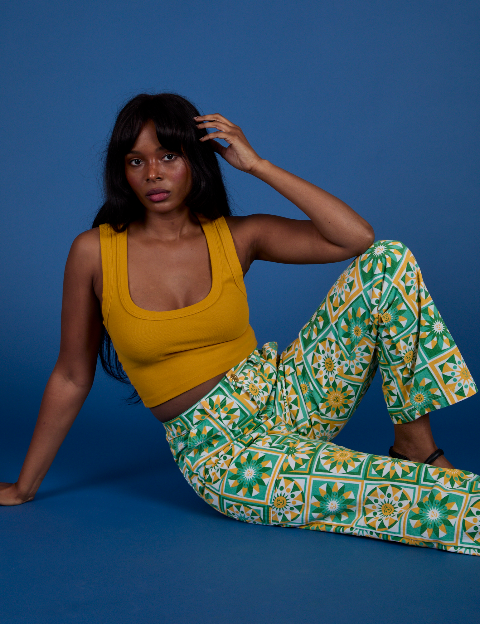 Kandia is wearing Work Pants in Spring Quilt Print paired with mustard yellow Cropped Tank