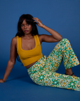 Kandia is wearing Work Pants in Spring Quilt Print paired with mustard yellow Cropped Tank