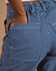 Close up of Kandia's hand in the back pocket of Railroad Denim Work Pants in Natural