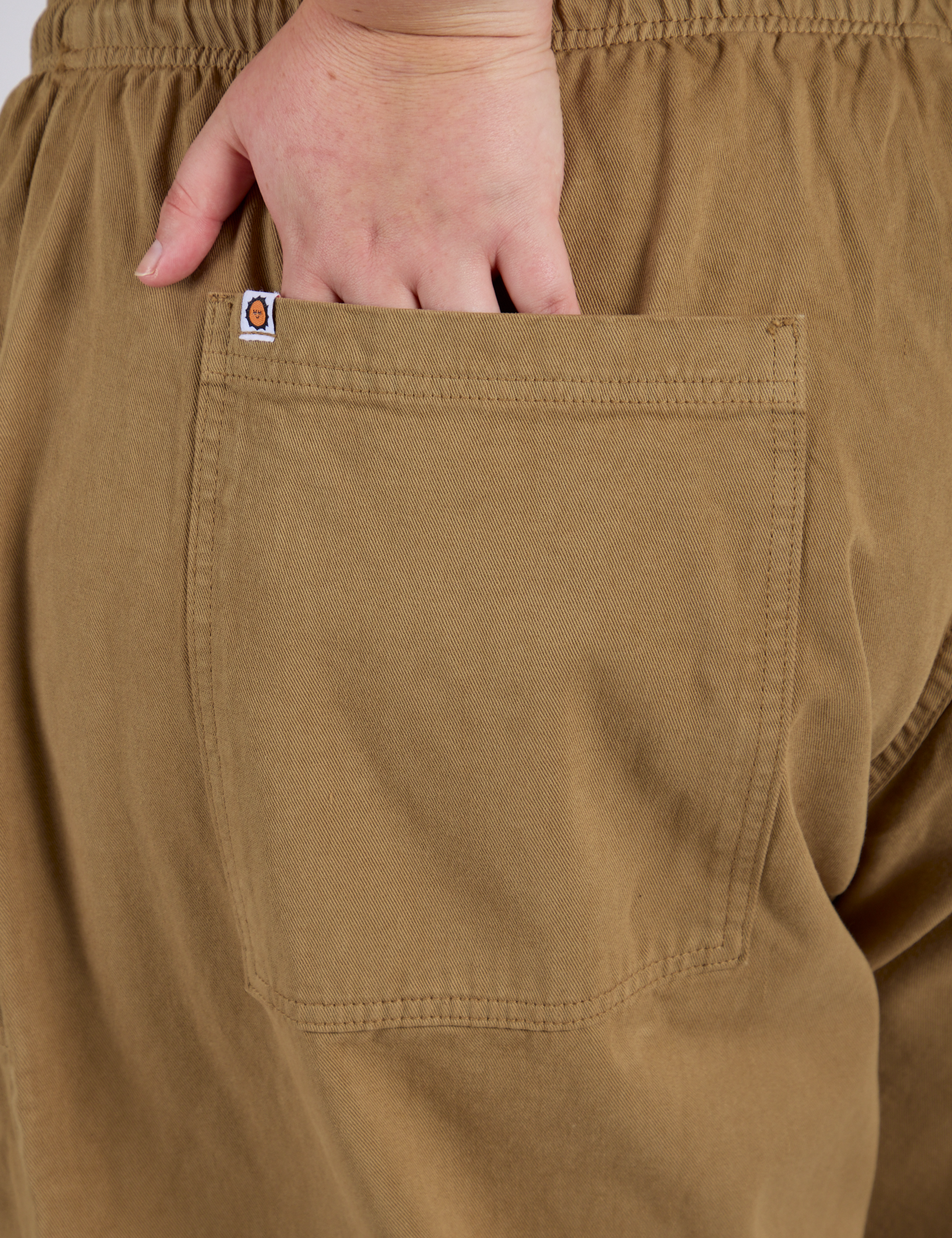 Close up of Juliet's hand in the back pocket of Drop Pocket Cargo Pants in Desert Brown