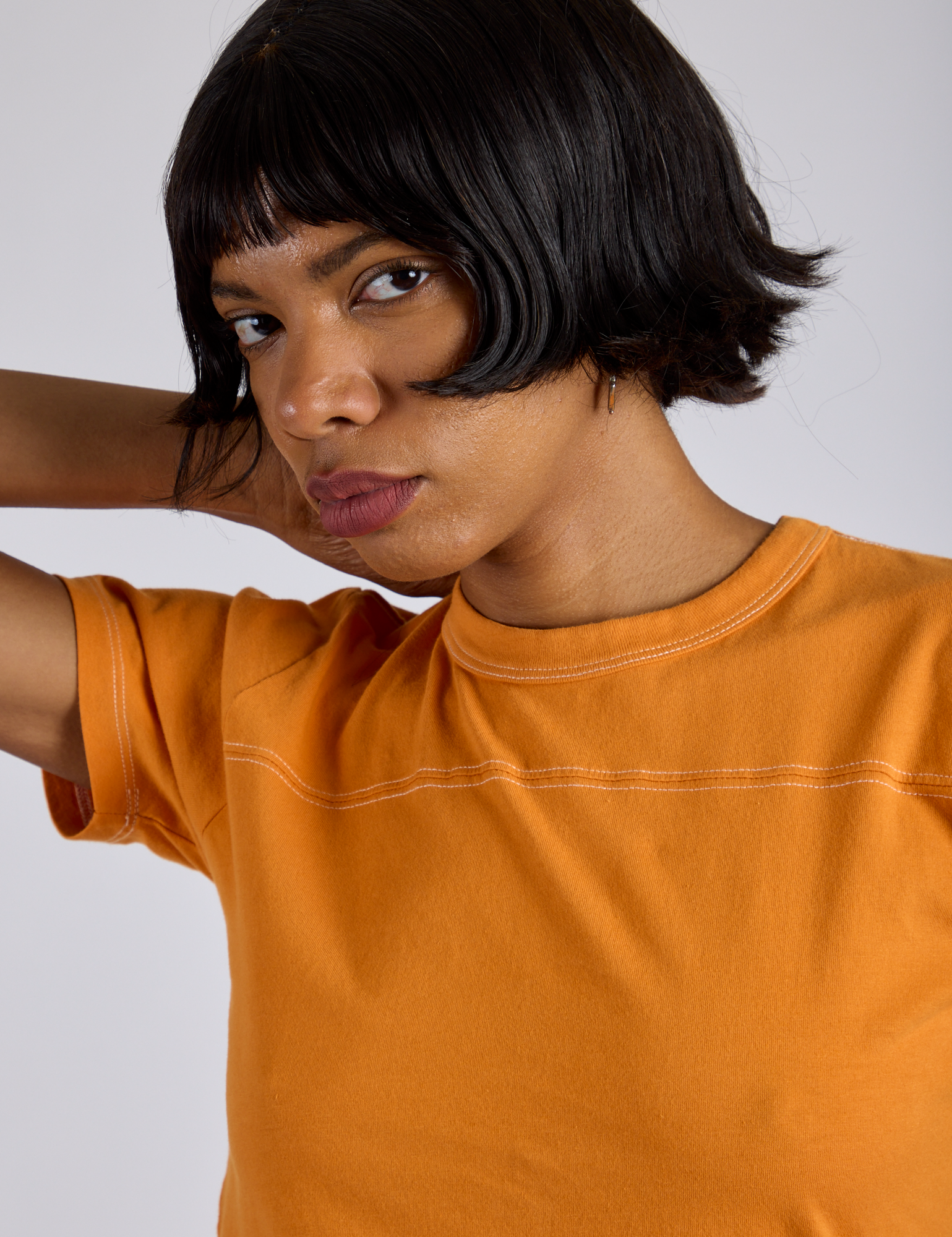 Jr. Varsity Tee in Creamsicle Orange front close up on Kira