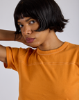 Jr. Varsity Tee in Creamsicle Orange front close up on Kira