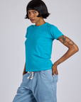 Angled front view of Jr. Varsity Tee in Hawaiian Blue on Kira