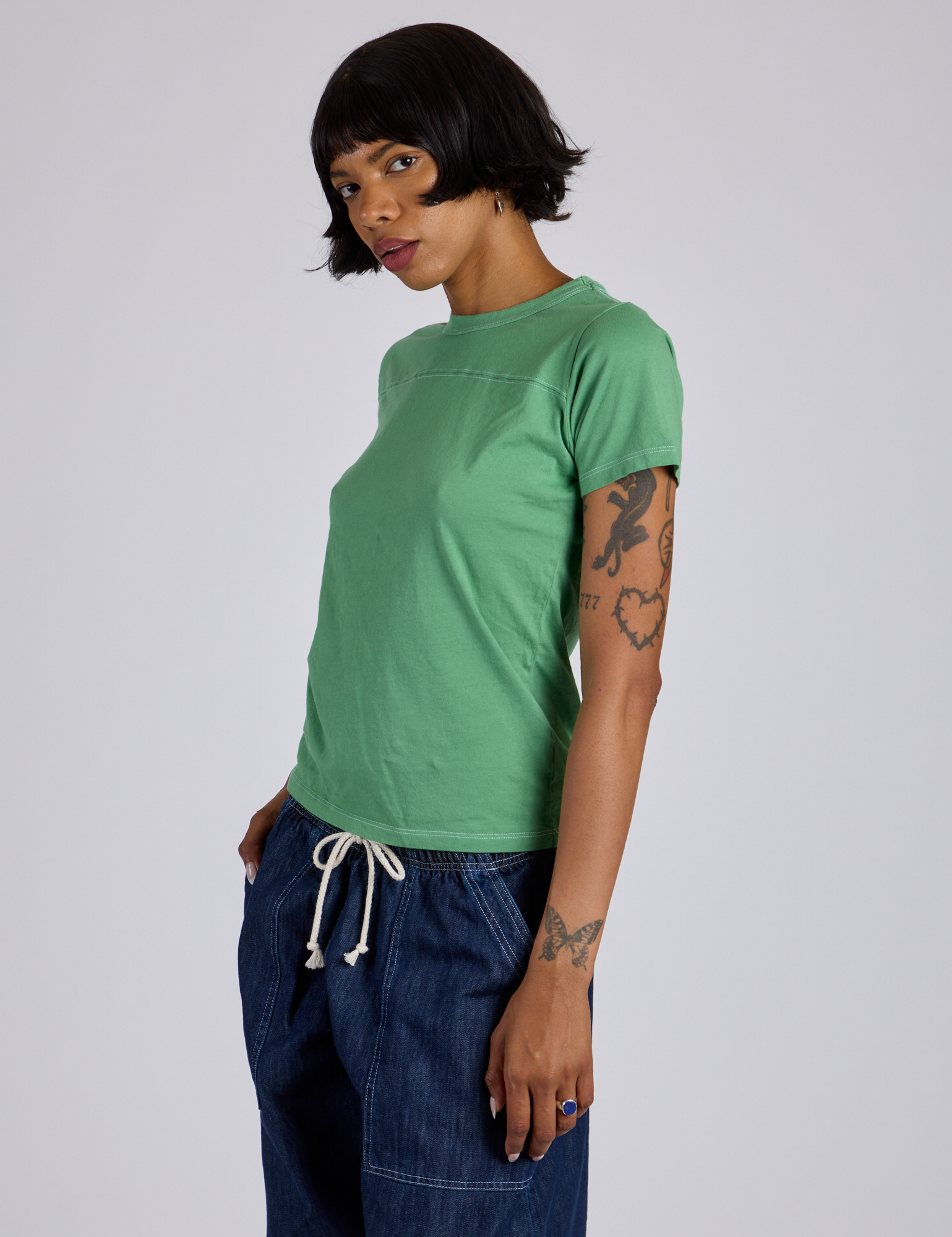 Jr. Varsity Tee in Seafoam Green angled front view on Kira