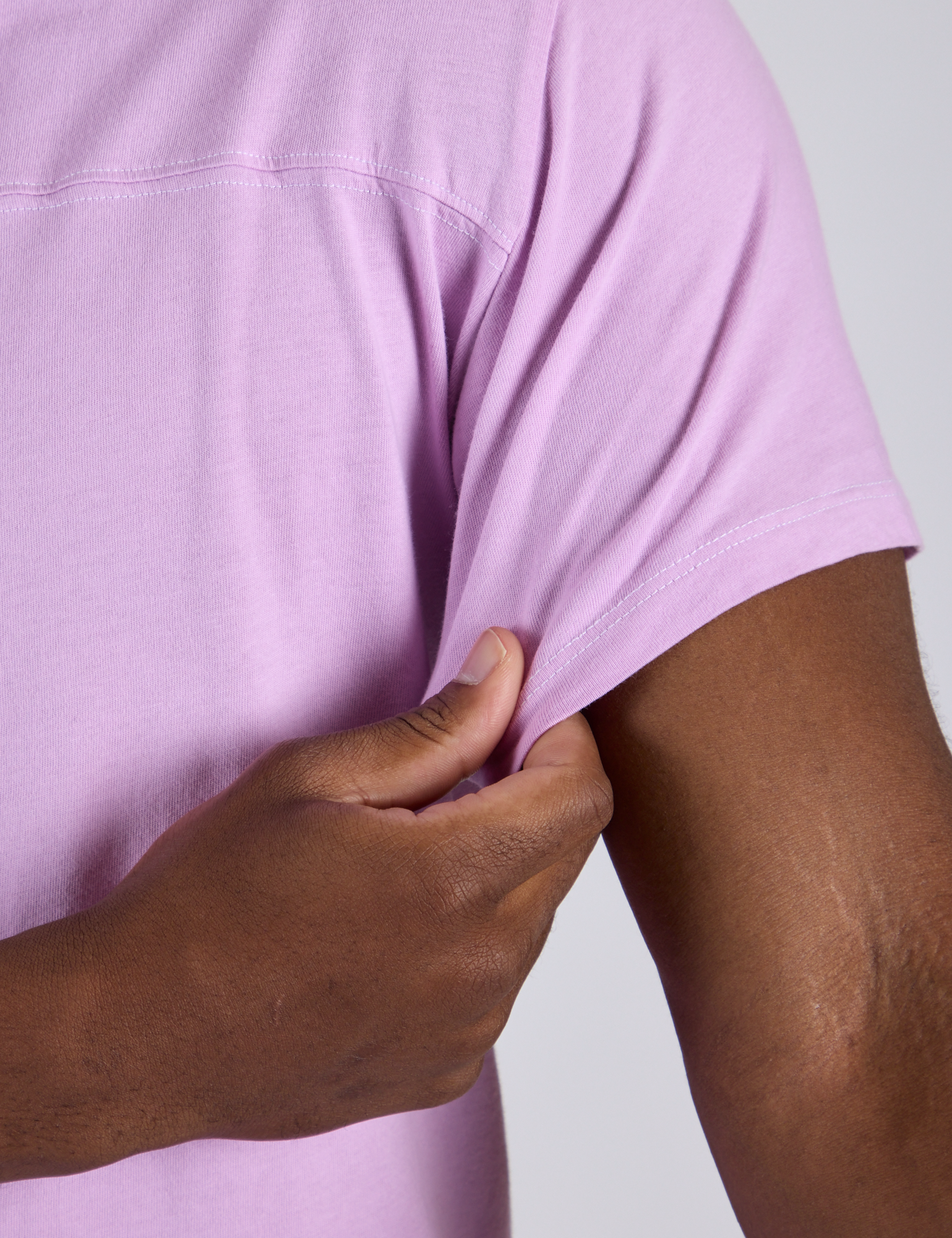 Close up of Jr. Varsity Tee in Lilac Purple sleeve on Isaac