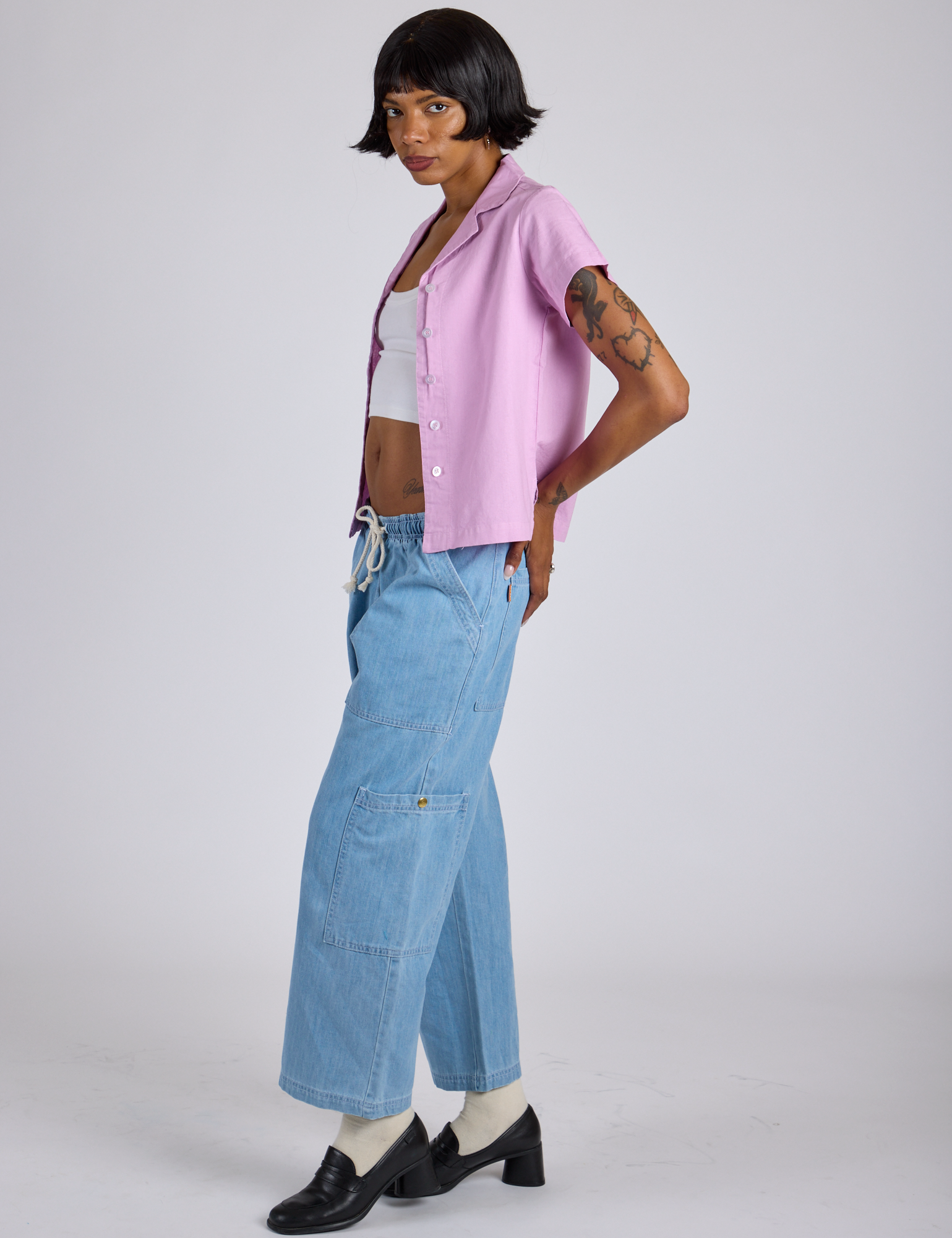 Side view of Pantry Button-Up in Lilac Purple and light wash Denim Drop Pocket Pants on Kira