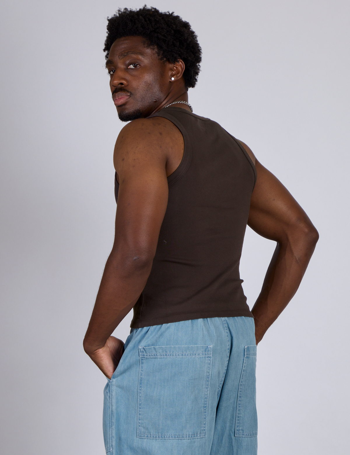 Angled back view of The Tank Top in Espresso Brown on Isaac