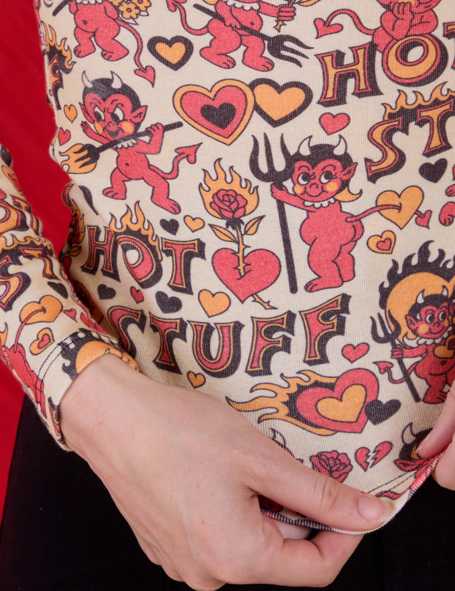 Long Sleeve Baby Tee in Hot Stuff Print close up on Alex