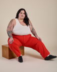 Work Pants in Mustang Red and vintage tee white Cropped Tank on Sam