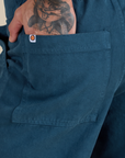 Close up of Jesse's hand in the back pocket of Work Pants in Lagoon