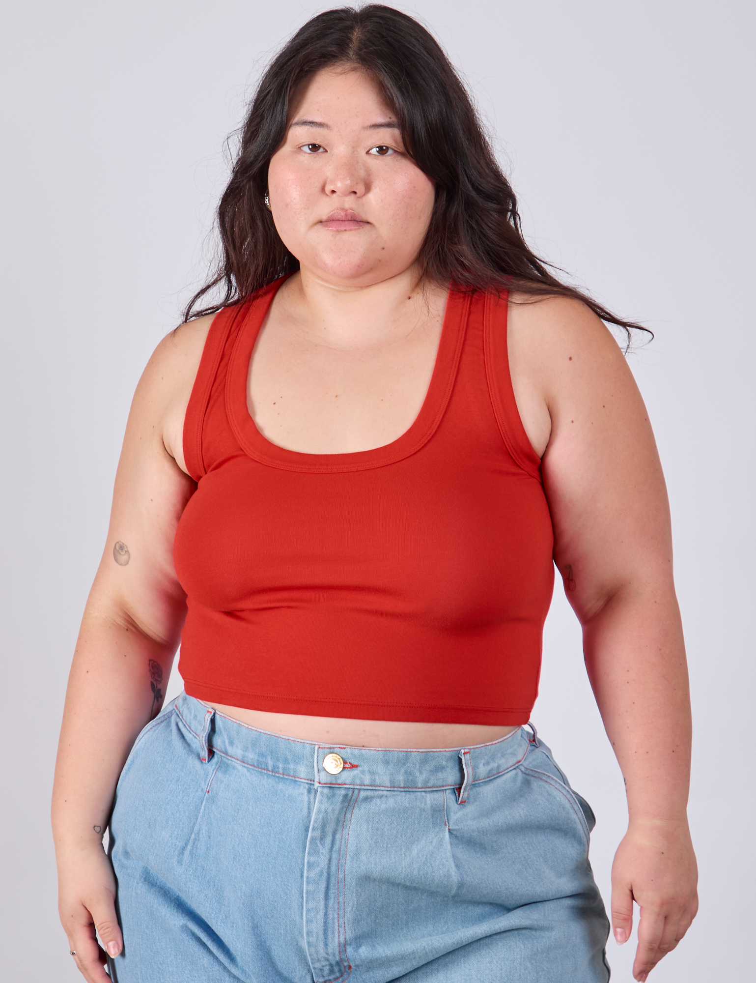 Ashley is 5'7" and wearing L Cropped Tank Top in Mustang Red