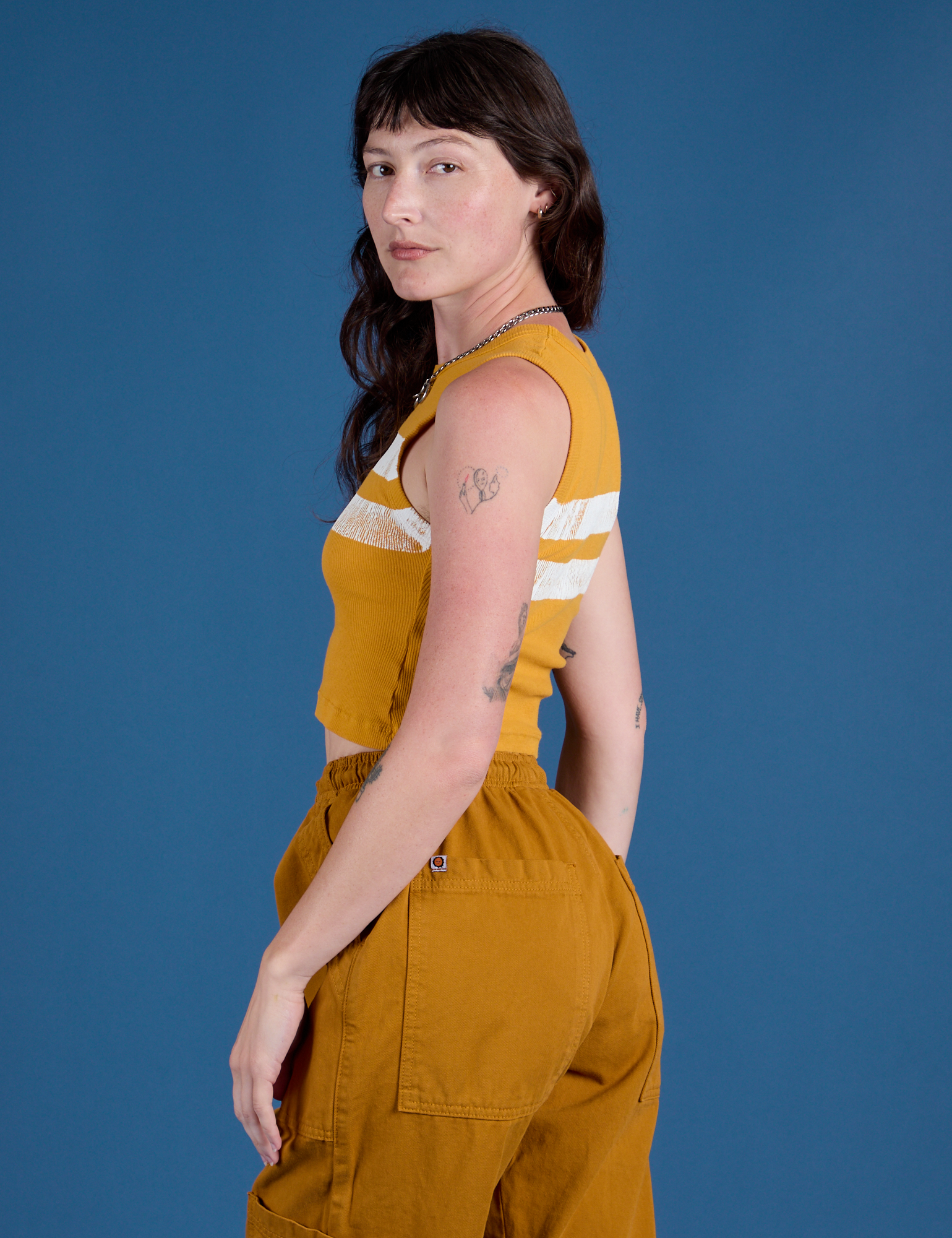 Painted Muscle Tee in Mustard Yellow side view on Alex