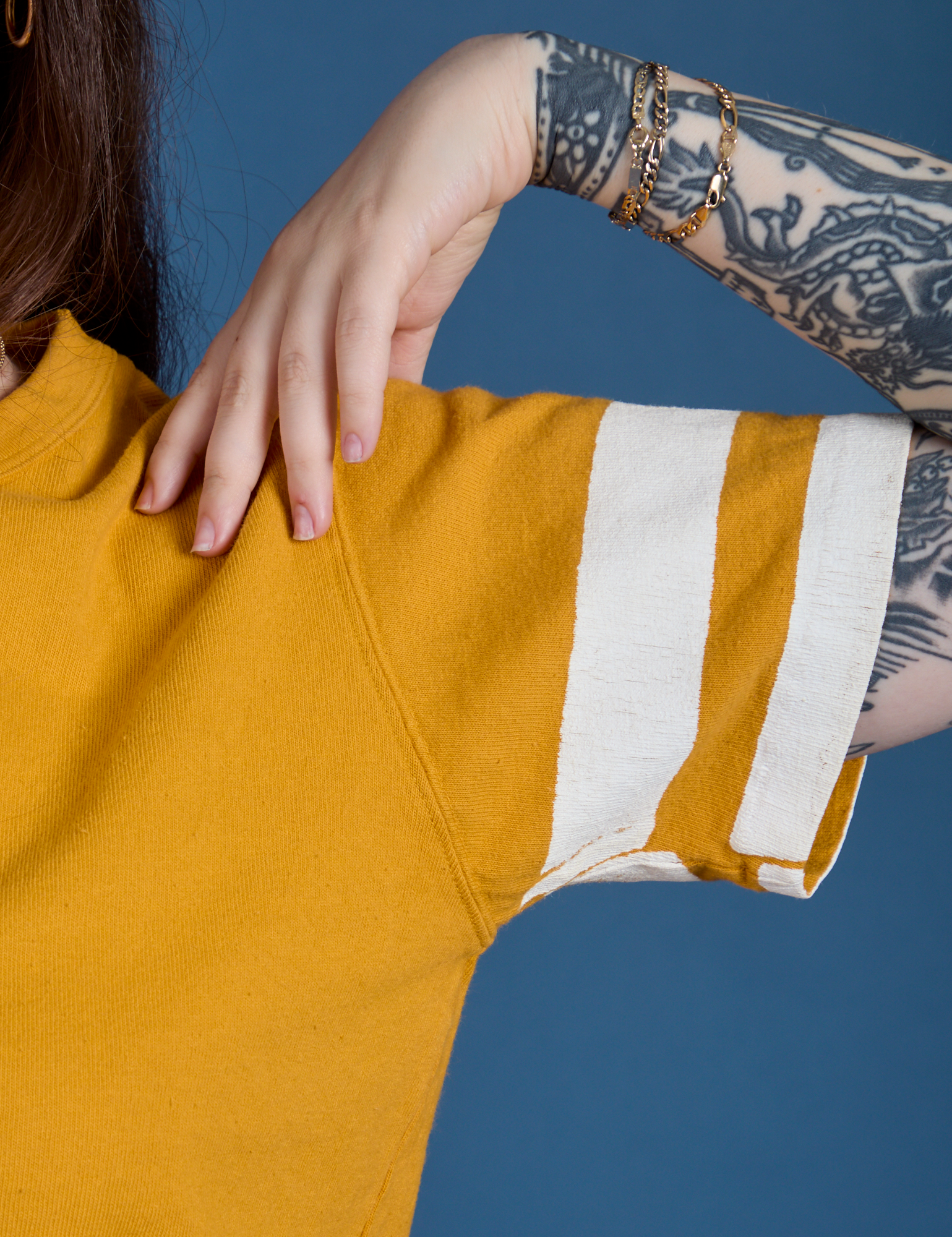 Painted Burly Tee in Mustard Yellow sleeve close up with two white painted stripes