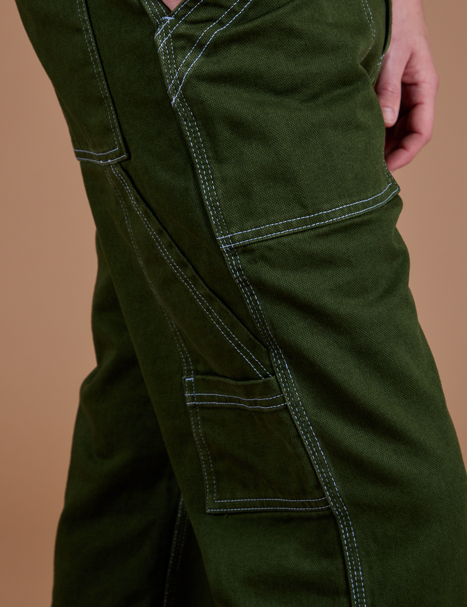 Carpenter Jeans in Evergreen pant leg side view close up on Quinn