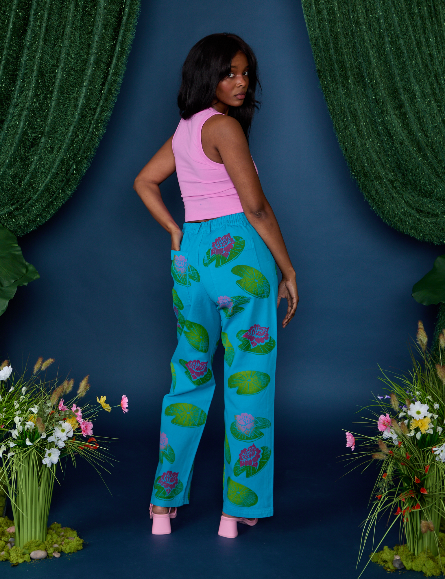 Angled back view of Paintstamped Work Pants in Lilypad and bubblegum pink Cropped Tank