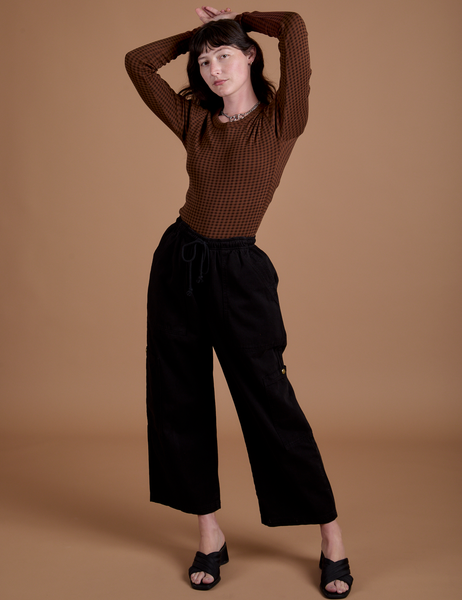 Gingham Long Sleeve Baby Tee in Fudgesicle Brown and black Drop Pocket Cargo Pants on Alex