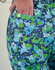 Close up of Shahana's hand in the back pocket of Angel Print Jumpsuit