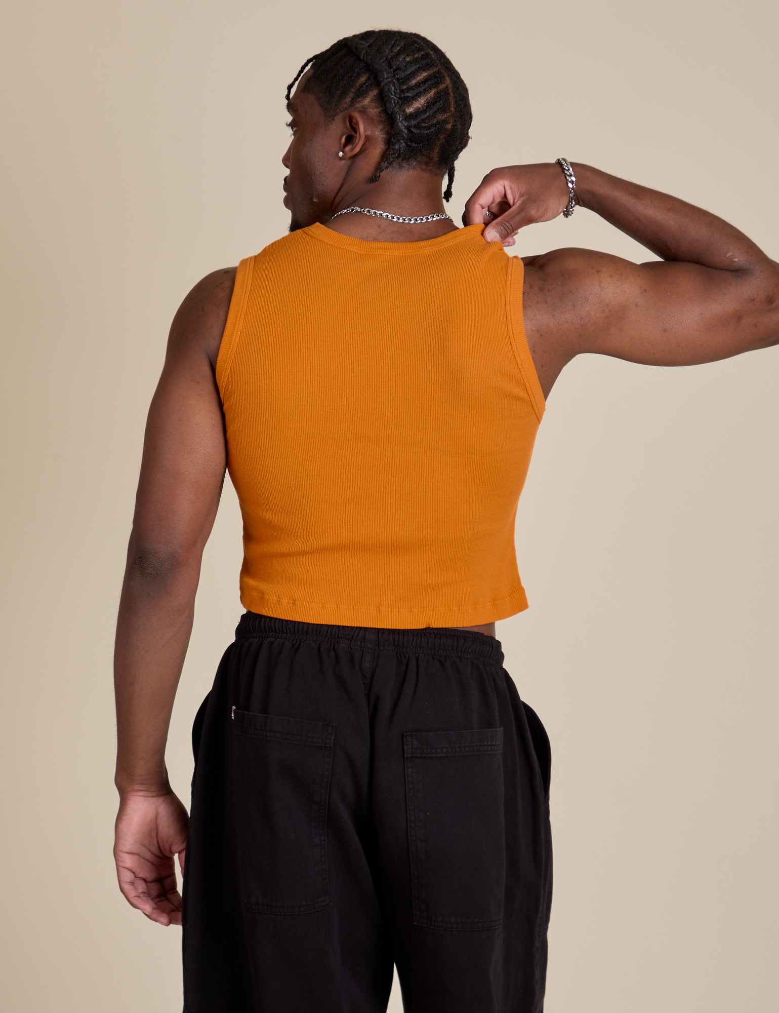 Muscle Tee in Creamsicle Orange back view on Isaac