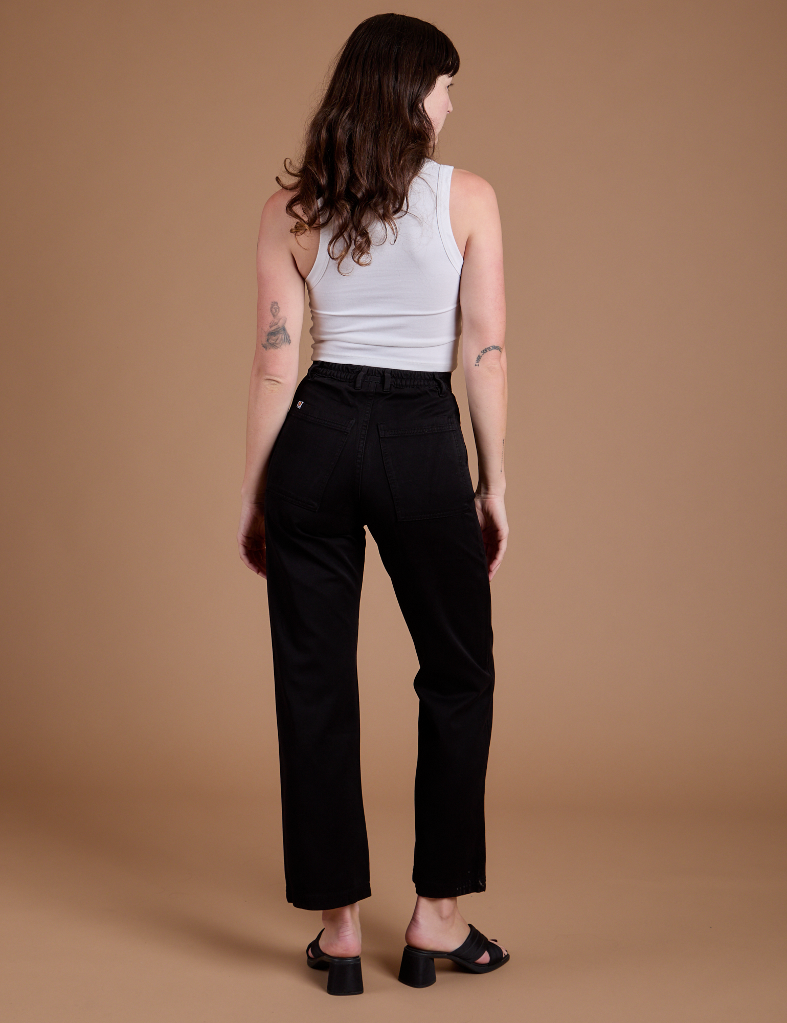 Back view of Organic Work Pants in Basic Black and vintage tee white Cropped Tank on Alex