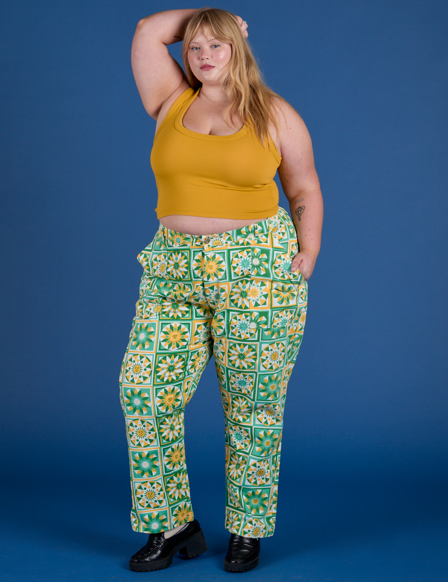 Juliet is 5’7” and wearing 2XL Work Pants in Spring Quilt Print and mustard yellow Cropped Tank