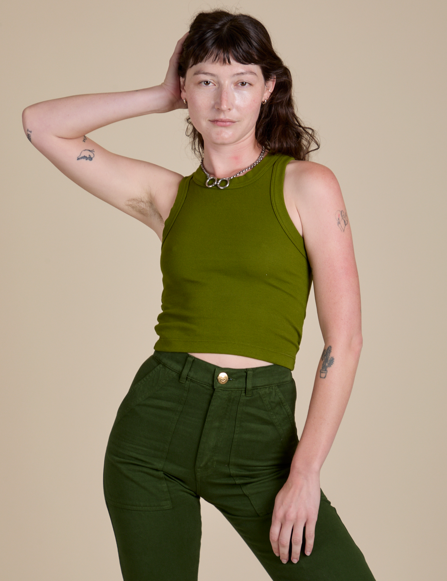 Alex is 5’8” and wearing P Racerback Tank in Summer Olive