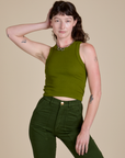 Alex is 5’8” and wearing P Racerback Tank in Summer Olive