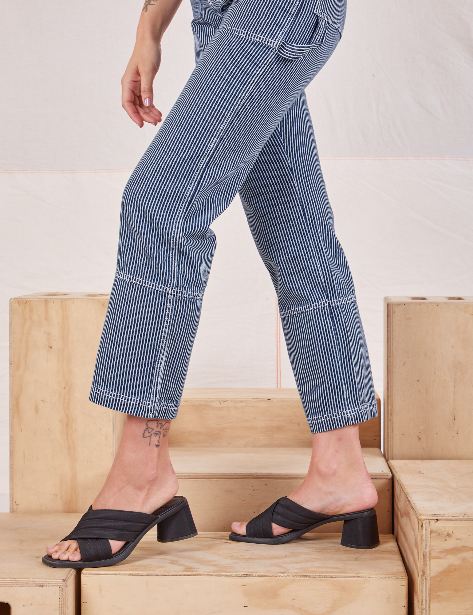 Carpenter Jeans in Indigo Railroad pant leg side close up on Alex