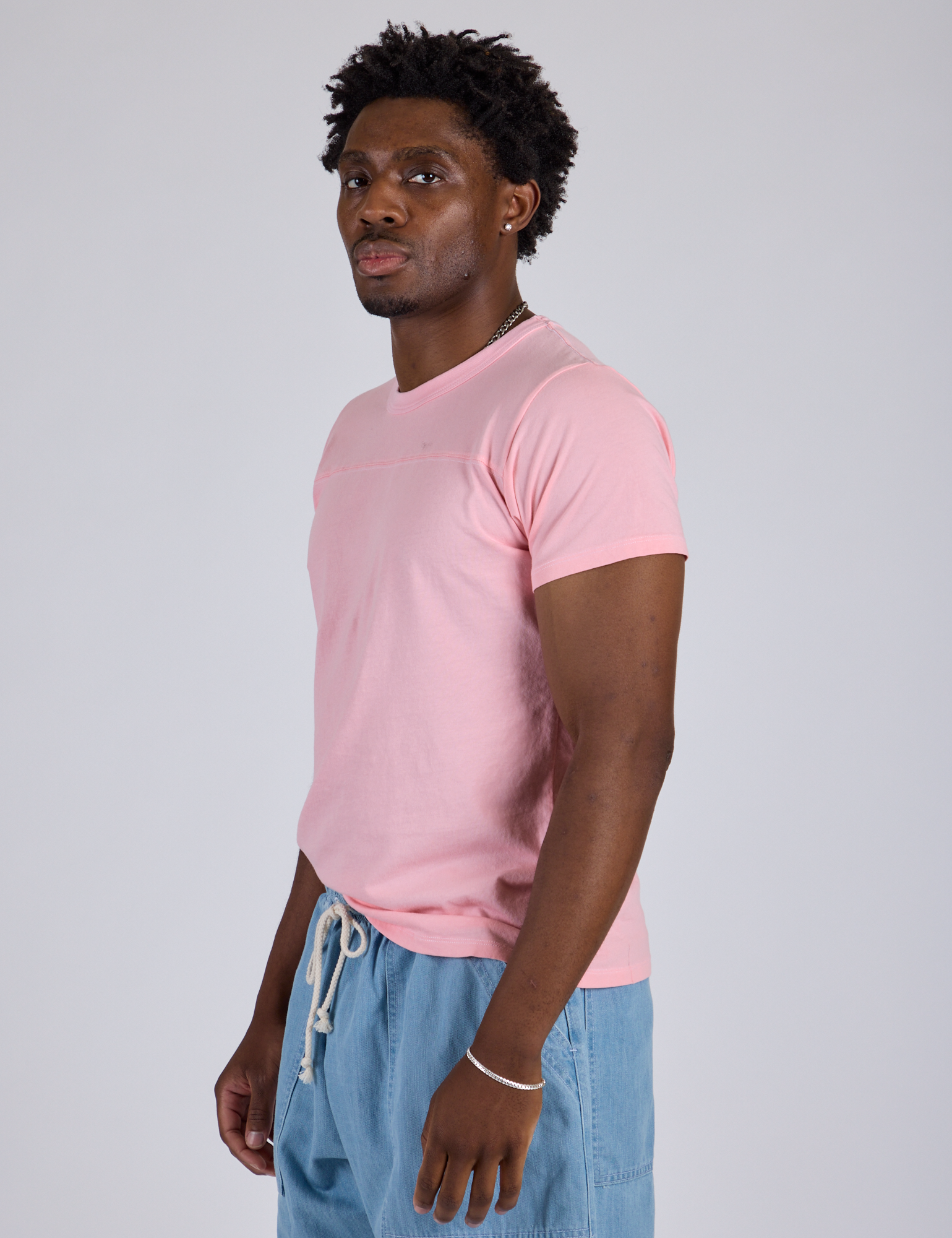 Jr. Varsity Tee in Baby Pink side view on Isaac