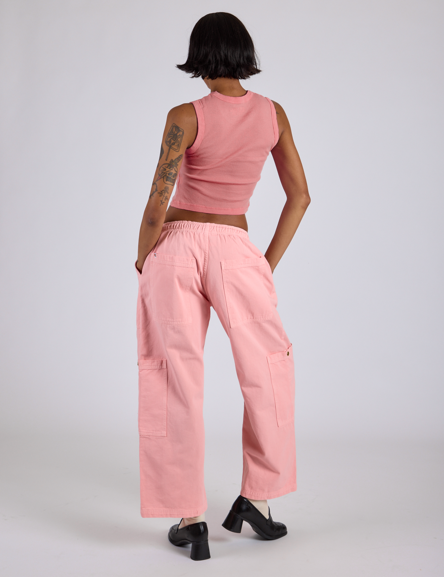 Back view of Drop Pocket Cargo Pants in Baby Pink and matching Muscle Tee on Kira