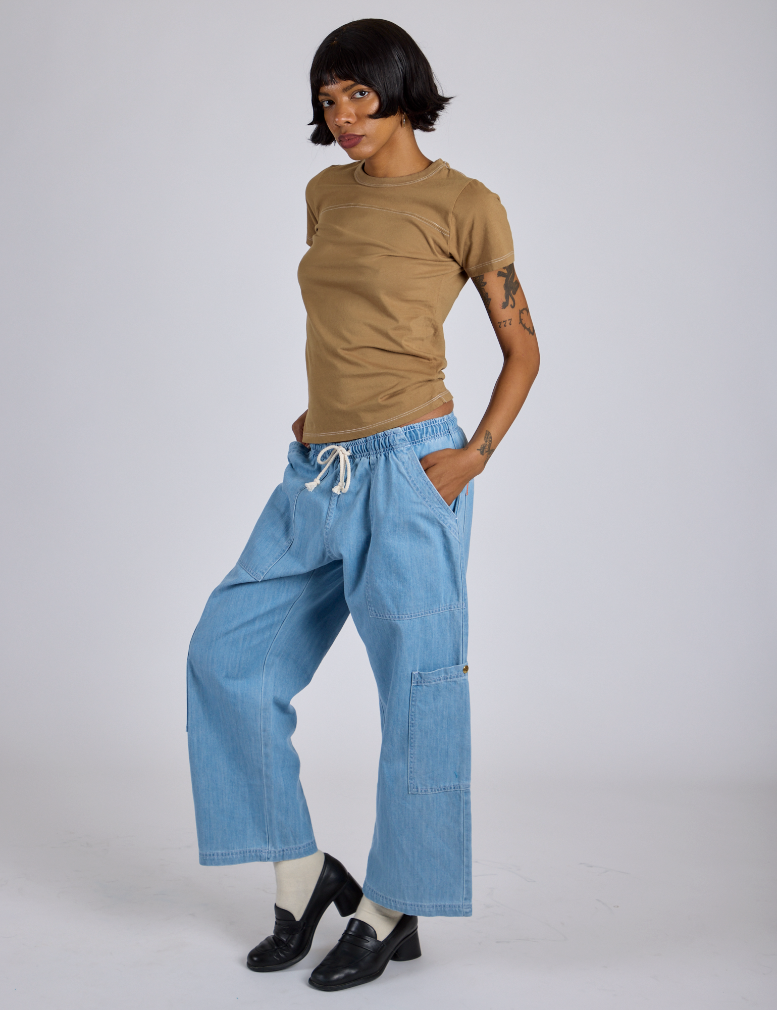 Angled front view of Jr. Varsity Tee in Desert Brown and light wash Denim Drop Pocket Pants