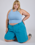 Juliet is wearing Longline Work Shorts in Hawaiian Blue and baby blue Racerback Tank