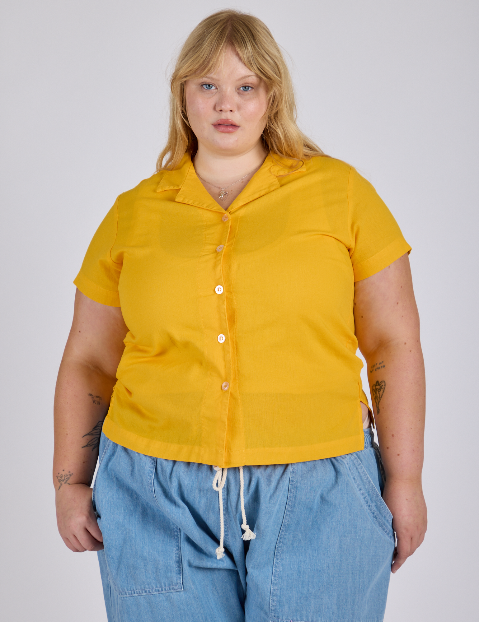 Juliet is wearing a buttoned up Pantry Button-Up in Sunshine Yellow