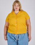 Juliet is wearing a buttoned up Pantry Button-Up in Sunshine Yellow