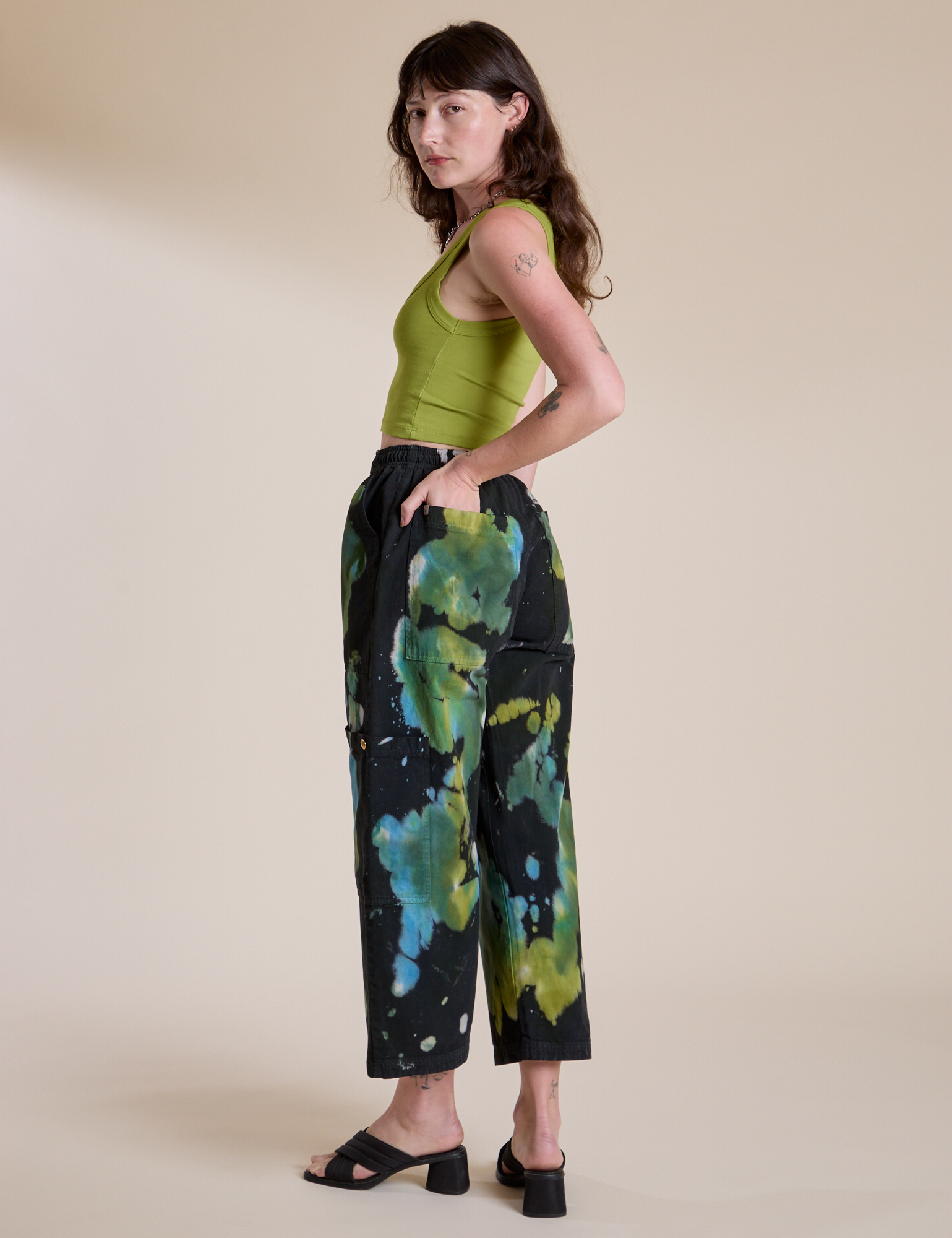 Angled back view of Magic Waters Drop Pocket Pants in Green Pool and gross green Cropped Tank on Alex