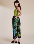 Angled back view of Magic Waters Drop Pocket Pants in Green Pool and gross green Cropped Tank on Alex
