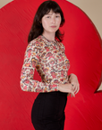 Side view of Long Sleeve Baby Tee in Hot Stuff Print on Alex