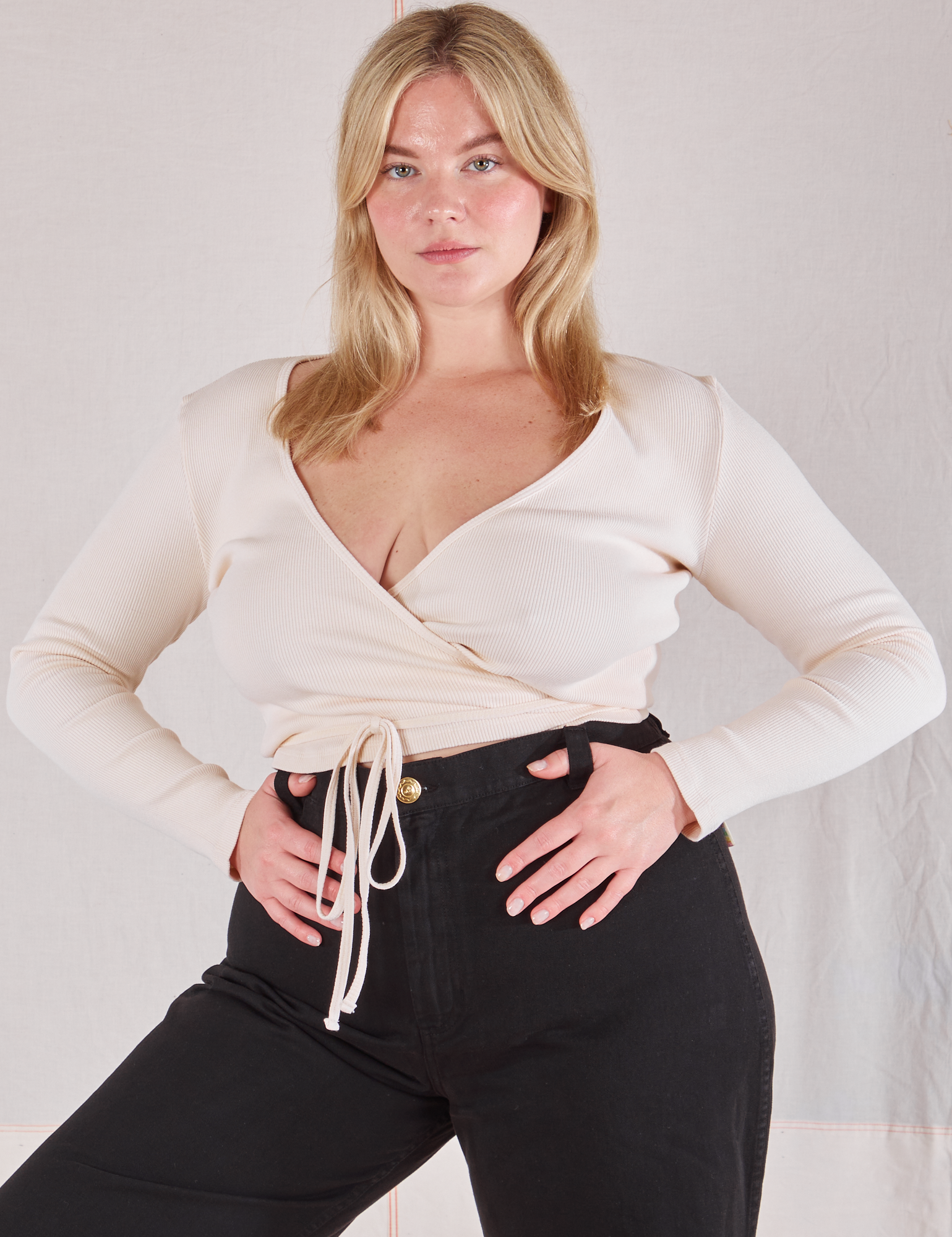 Lish is wearing Wrap Top in Vintage Tee Off-White and black Bell Bottoms