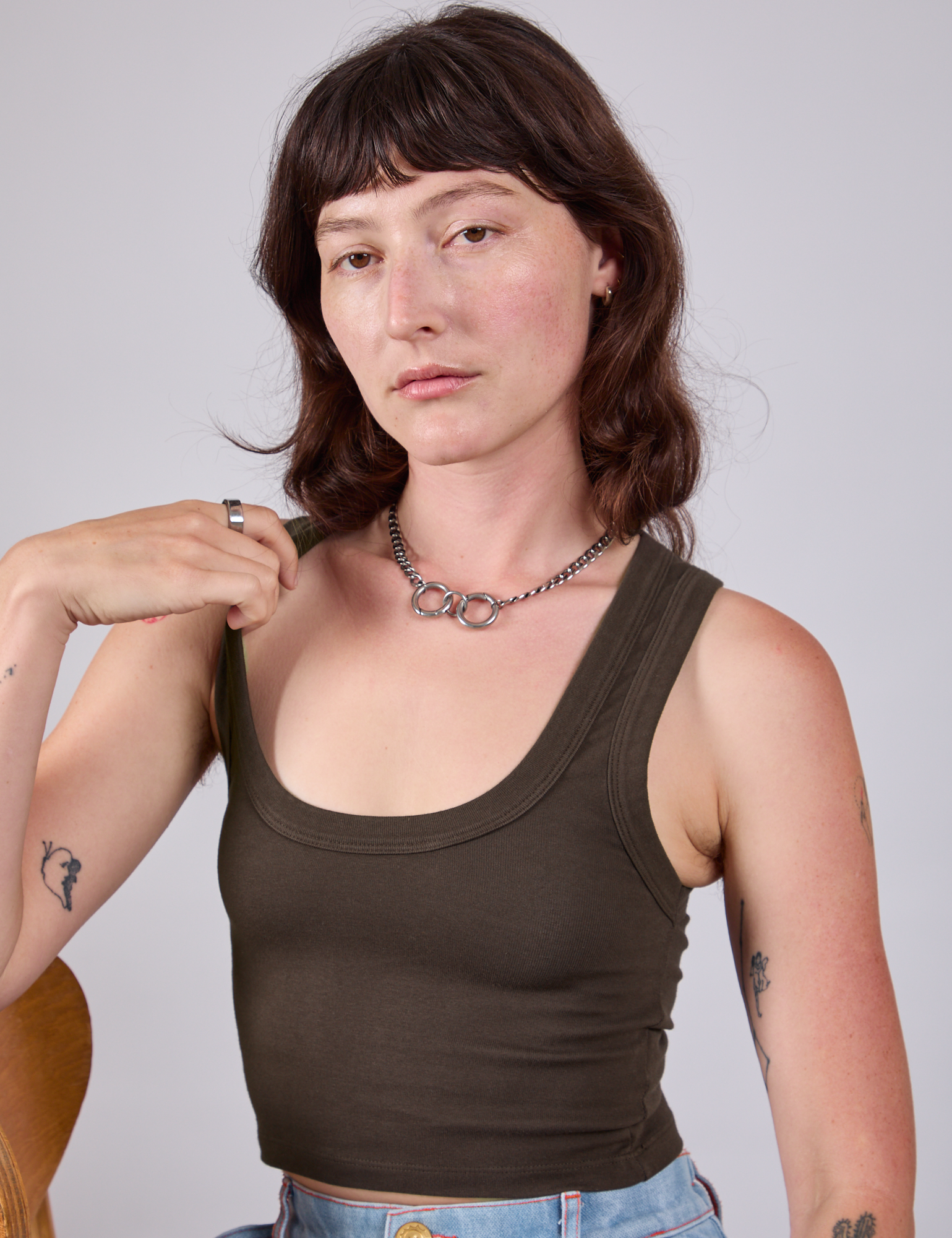 Alex is 5'8" and wearing P Cropped Tank Top in Espresso Brown