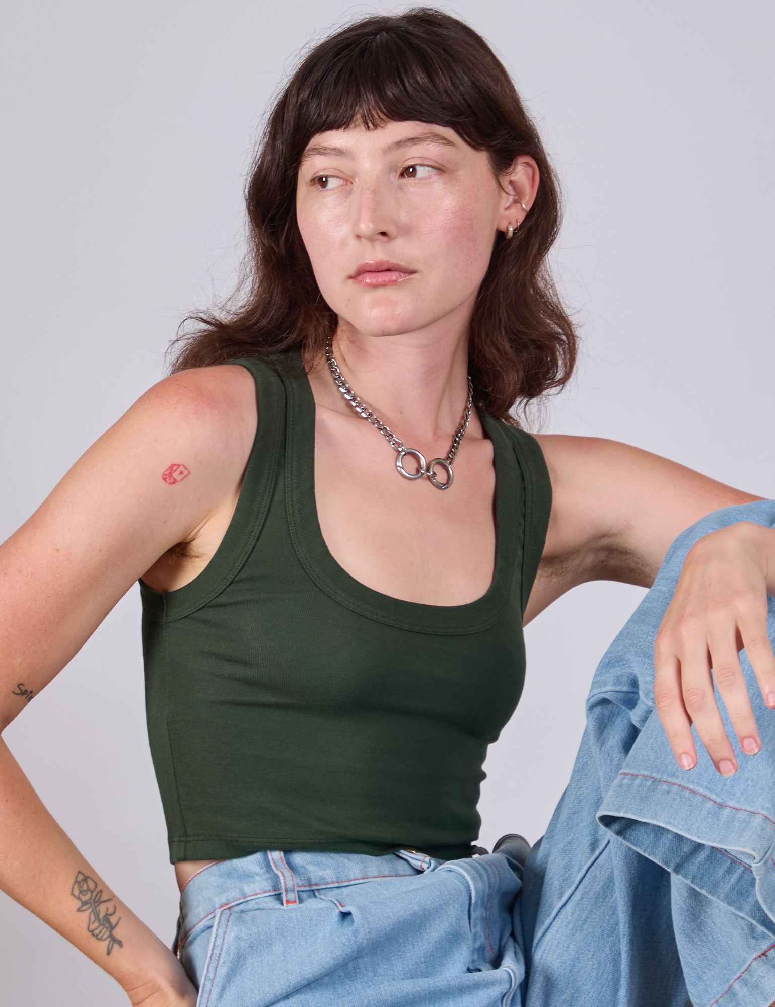 Alex is 5'8" and wearing P Cropped Tank Top in Swamp Green